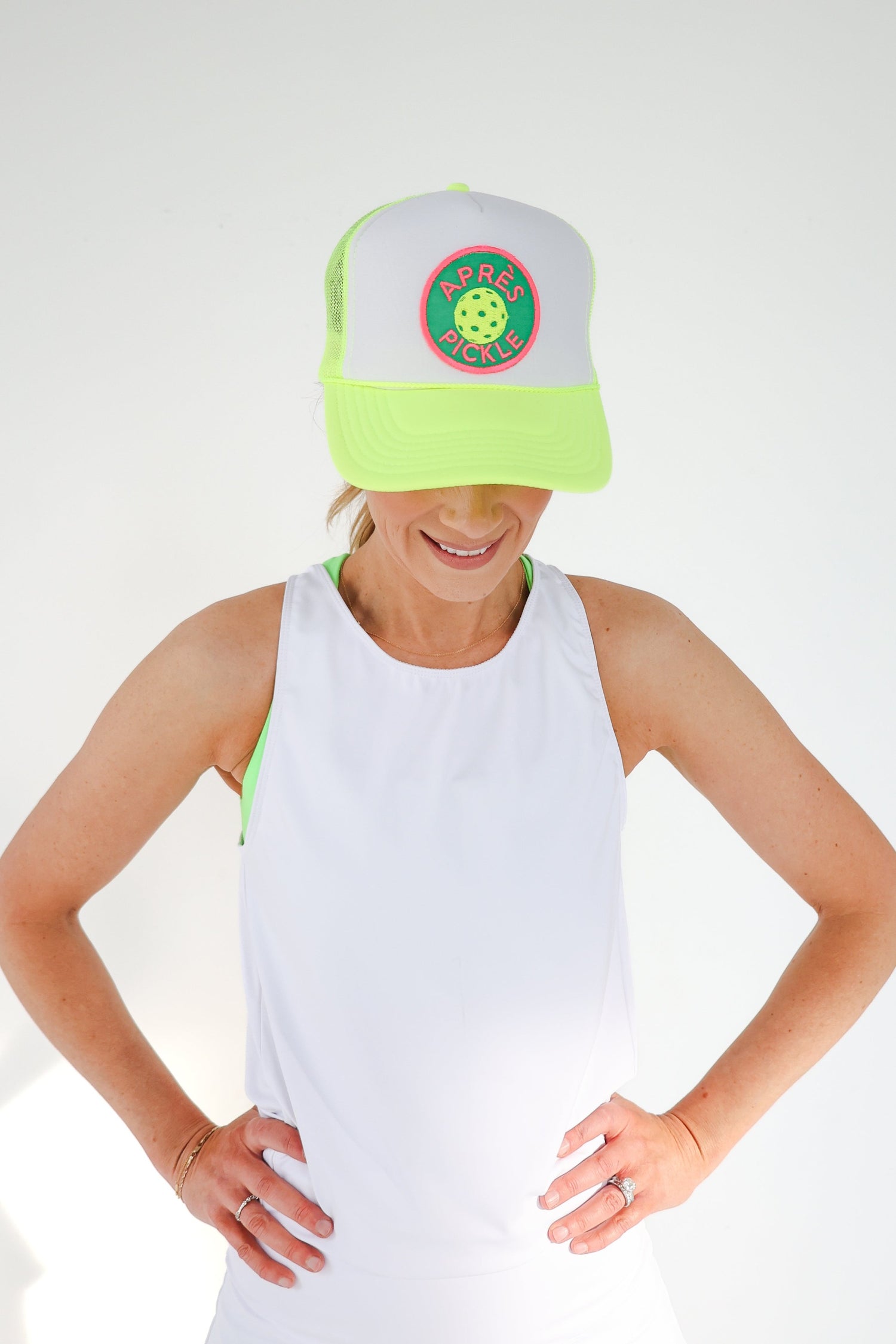 A neon yellow and white foam trucker hat with a custom 
