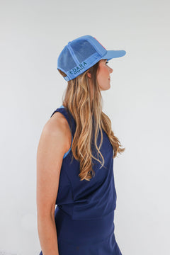A beautiful blue foam trucker hat with a custom "Apres Tennis" patch for all tennis enthusiasts.