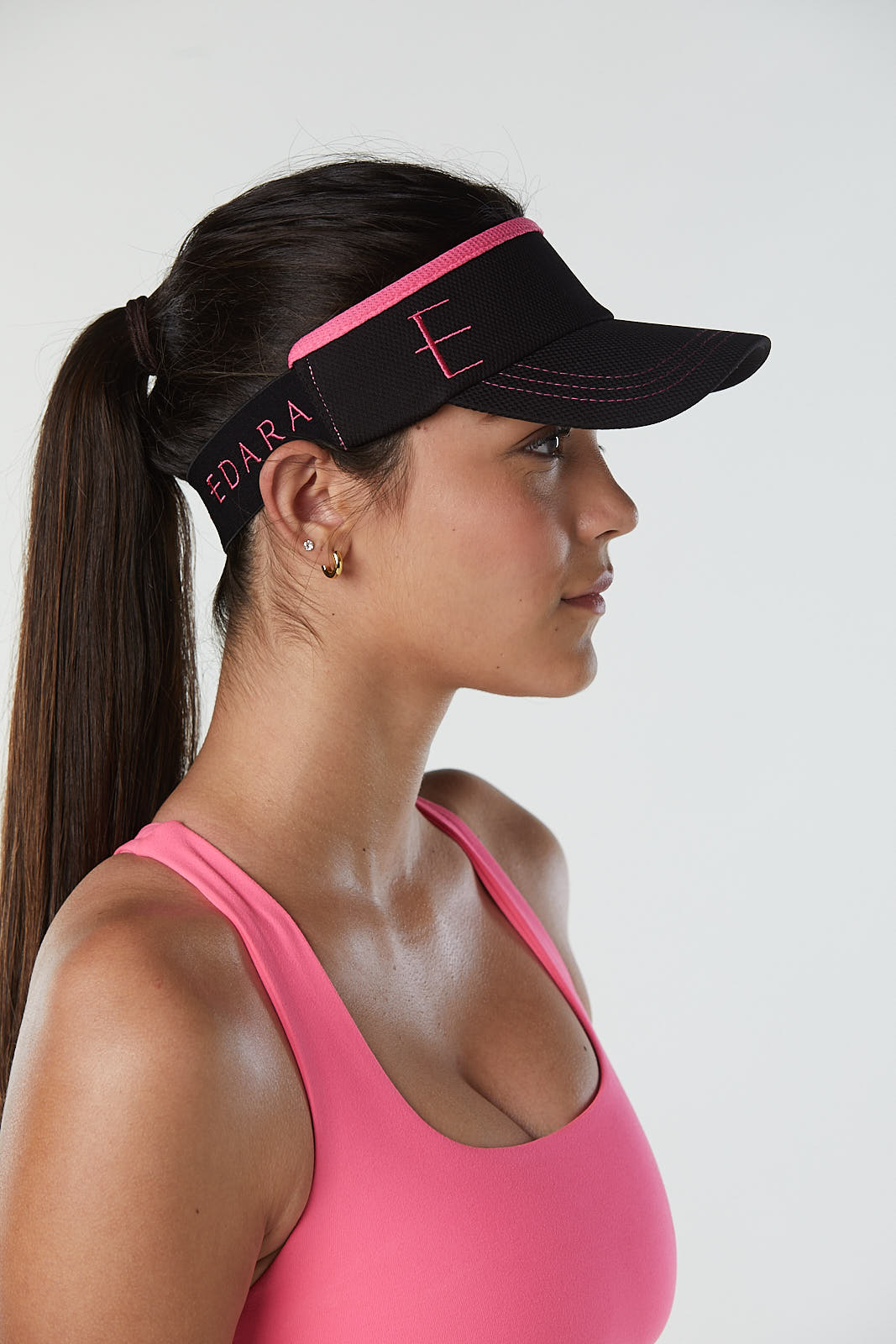 Black tennis visor with pink accents for women.