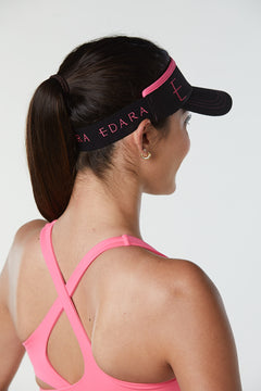 Black tennis visor with pink accents for women.