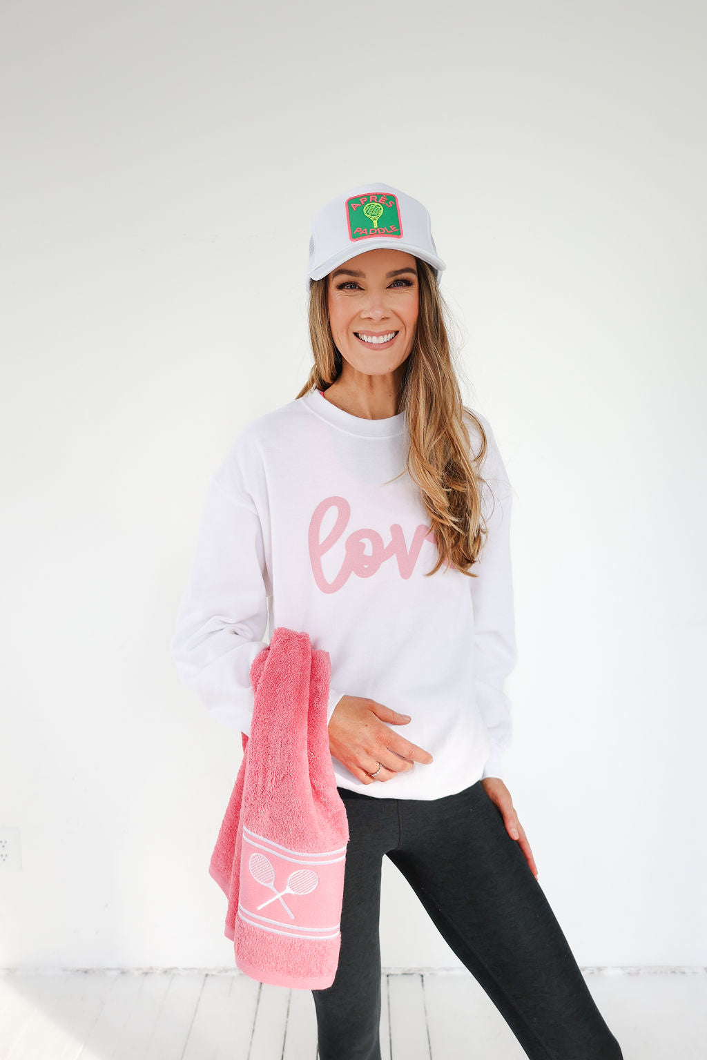 A terry sports towel in either pink or yellow with tennis racket icons embroidered on for a chic and practical item to keep in your tennis bag.